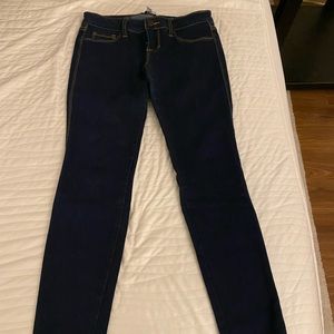 Dark blue skinny jeans with bronze/tan stitching. Size 5